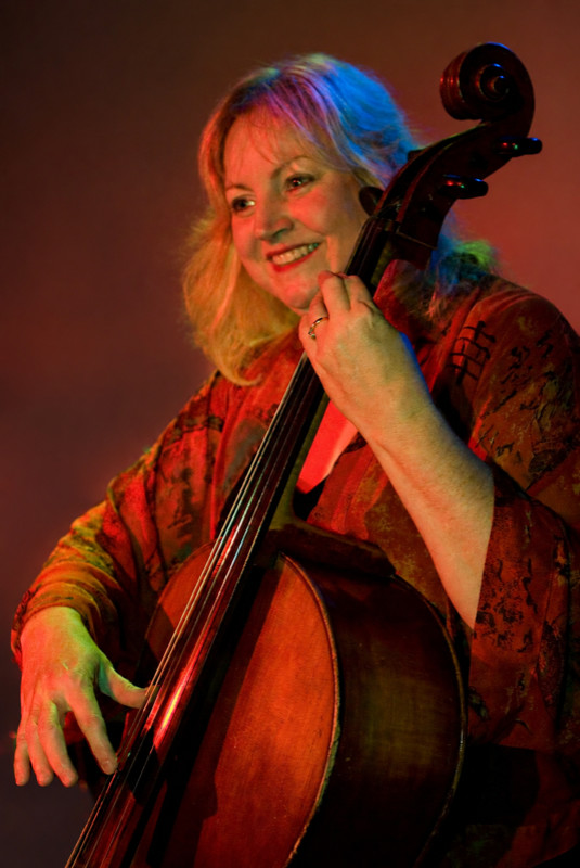 Laurie Haines Reese playing the cello under stage lights